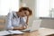 Stressed young female general practitioner looking at laptop screen.