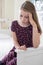 Stressed Young Girl In Sitting Bedroom At Home