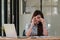 Stressed young woman sitting at desk working from home office, businesswoman headache while having a problem at work in