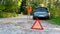 Stressful young woman driver hitchhikes and stops cars, asks for help as have problem with brocken car, uses red triangle sign