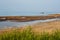 A stretch of the Apulian coast with posidonia algae and seagulls and fishermen`s boats in the background