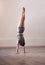 Stretch beyond the limits. Full length shot of an athletic young woman doing a hand stand in studio.