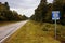 A stretch of the original route 66 wih a road sign in a rural area of the State of Missouri