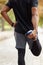 Stretch it out before you start. Rearview shot of an unrecognisable man stretching his legs while exercising outdoors.