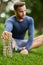 Stretch properly to avoid injury. a handsome young male runner warming up before his workout.