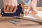 Stretching the canvas on a stretcher in the artist`s studio. Women`s hands with a stapler fasten the canvas to a wooden frame