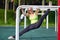 Stretching danser or gymnast woman training trains on uneven bars in workout sports ground. Good stretching, twine