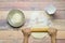 Stretching dough with rolling pin on wooden table