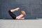 Stretching woman. fitness or gymnast or dancer doing exercises on gray wall uban background