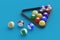 Strewn billiard balls in plastic triangle. Game for leisure. Sports equipment