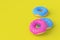 Strewn donuts on yellow background