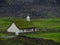 Streymoy, Saksun. View on Saksun`s church and valley. White building with grass roof standing out of the green
