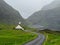 Streymoy, Saksun. View on Saksun`s church and valley. White building with grass roof standing out of the green