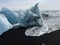 A striated chunk of iceberg washed up on a beach in Iceland