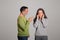 Strict angry caucasian aged husband scolds his wife, lady covers ears
