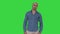 Strict arabic man standing and looking into camera on a green screen, chroma key.