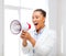 Strict businesswoman shouting in megaphone