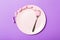 Strict diet concept with empty space fro your design. Top view of plate with fork in measuring tape on purple background