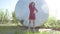 Strict girl. A serious girl stands near a barrel of petrol oil. An old barrel oil