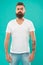 Strict and serious. Beard fashion and barber concept. Man bearded hipster stylish beard turquoise background. Barber
