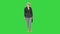 Strict serious-looking elder woman standing and looking to camera on a Green Screen, Chroma Key.