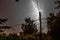 Strike of a strong lightning during a thunderstorm