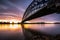 Striking arch bridge spans the river during the sunrise