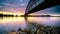 Striking arch bridge spans the river during the sunrise