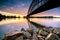 Striking arch bridge spans the river during the sunrise