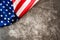 Striking colored American flag  in a corner on a stone gray background