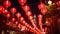 A striking image featuring a multitude of red lanterns adorning a wire, casting a warm glow in the evening, Red lanterns adorning