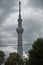 Striking image of the Tokyo Skytree tower standing tall against the backdrop of a cloudy sky