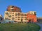 A striking modern apartment building bathed in warm evening sunlight