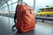 A striking red backpack in the airport, a traveler\\\'s essential carry on