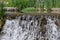 Striking setting with small waterfall running through.