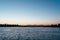 Striking sunset above the lake with bright clouds and sky