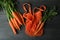 String bag and carrot on dark wooden background