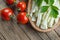 String cheese in bamboo bowl with cherry tomatoes on wooden background