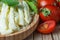 String cheese in bamboo bowl with cherry tomatoes on wooden background