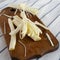 String cheese on rustic wooden board, side view. Healthy snack. Close-up