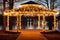 a string of lights attached to a lakeside gazebo