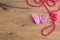 A string of pink beads displayed with a butterfly