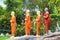 A string of statues of Buddhist monks in orange tones in a Buddhist temple in Sri Lanka