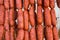 Strings of Hand Crafted Artisanal Sausages Red Chorizo Hanging at Farmers Market. Traditional Spanish Meat Specialty