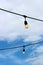 Strings of old fashioned light bulbs draped overhead on downtown street