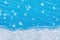 A strip of natural snow on blue glass winter background