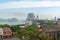 Strip of white cloud crosses sky over Sydney Harbour bridge and mist hangs over harbour and city in view from Observatory Hill