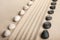 Stripe of white and black stones lying on the sand