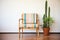 striped accent chair beside a bamboo plant