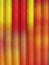 Striped background in vertical motion blured lines in red and yellow